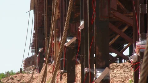 Mining of a metal structure with a red dynamite block TNT. Blasting Specialists Stock Footage 138831679