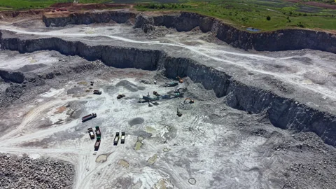 Mining operation in a quarry with heavy machinery working on stone extraction in Stock Footage 342464229