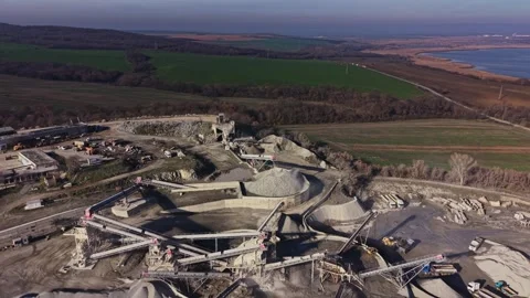 Mining operation in a quarry near the coast capturing industrial activity Stock Footage 329998613