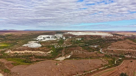 Mining operations in a remote area with clear skies and textured clouds observed Stock Footage 345456707