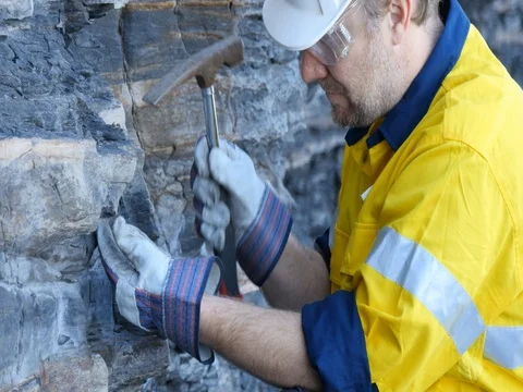 Mining prospect mineral exploration Geologist taking field rock data sample Stock Footage 78587790