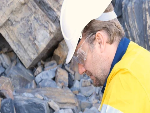 Mining prospect mineral exploration Geologist taking field rock data sample Video stock 78589852
