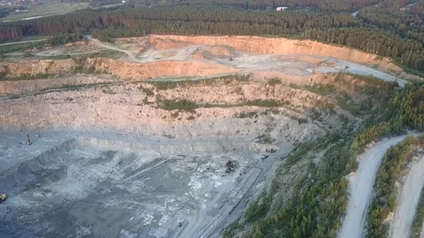 Mining quarry with outdated machines surrounded by roads Stockbeeldmateriaal 115667534
