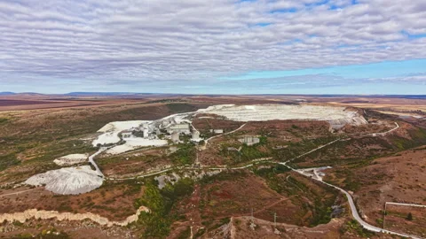 Mining site located in a remote area shows excavation and landscape changes from Stock Footage 345456669