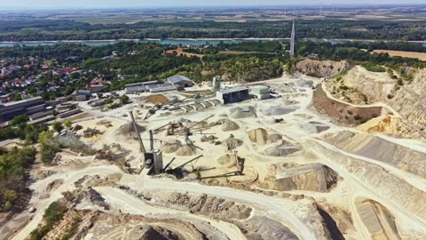 Mining site located in a valley with machinery and structures during daylight Stock Footage 344114770