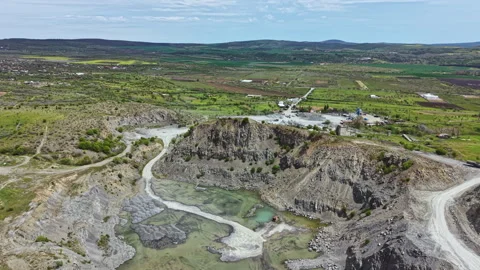 Mining site with machinery and equipment located in a rural area during the Stock Footage 342477790