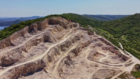 Mining site in a mountain area during daytime with clear sky Stock Footage 338276006