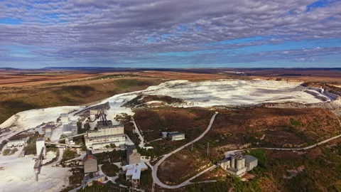 Mining site in a quarry with buildings and machinery visible near a landscape of Stock Footage 345456704