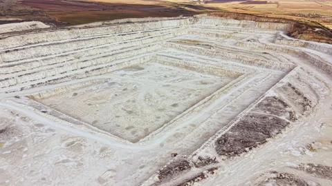 Mining site showing large excavation area for minerals and raw materials located Stock Footage 345457684