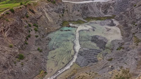 Mining site shows excavation area with water collection in pit Stock Footage 338275925