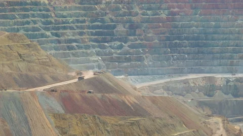 Mining trucks driving in huge copper mine - telephoto shot Stock Footage 57275337