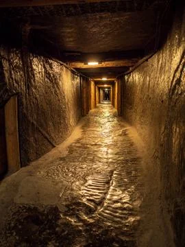 Mining tunnel with stone path deep underground Stock Photos