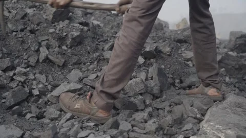 Mining worker digging coal surface using hand tool Stock Footage 318501888