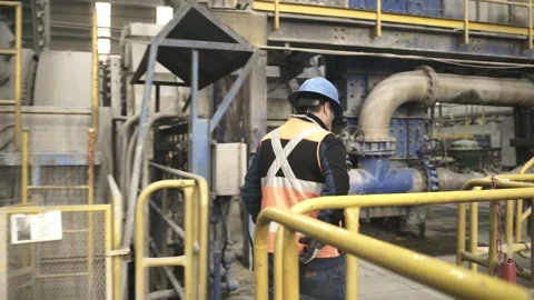 Mining Worker Walking Near Operating SAG Mill at El Teniente Mine Stock Footage 339378809