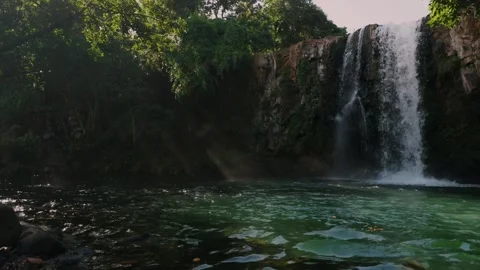 Minissy waterfall in Mauritius with sun rays shining through water mist Видео 342238867