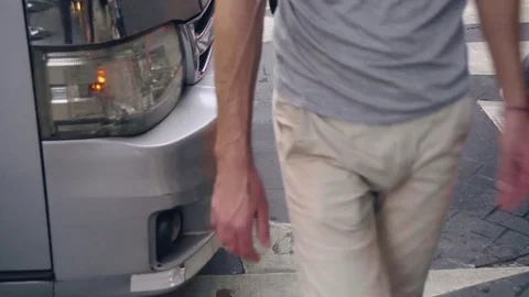 Minivan abruptly stopping in front of pedestriants crossing street at crosswalk Stock Footage 81620635