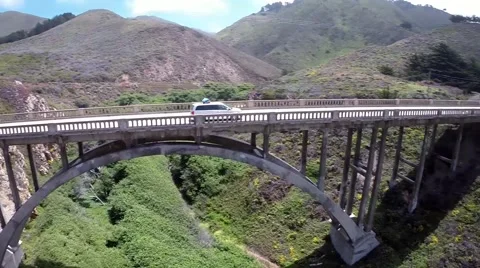 Minivan crossing cement bridge aerial shot Stock Footage