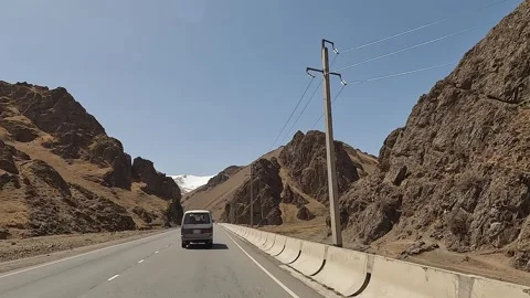 The minivan drives along a beautiful mountain road Stock-Footage 241381577