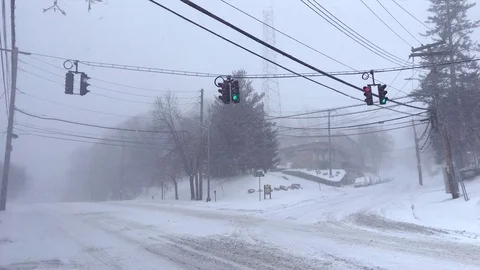 Minivan Drives Through Lonely Intersection During Snowstorm Stock Footage 85282518