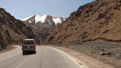 The minivan is driving through an amazing mountain gorge Stock Footage 241381909