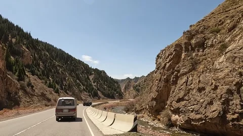 The minivan is driving through a beautiful mountain gorge Stock Footage 241381813