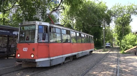 Minivan slowly moves along cobble-paved tramway segregation Stock Footage 64638758
