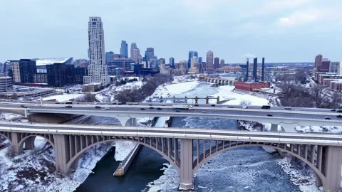 Minneapolis skyline on cloudy winter day with frozen Mississippi River in Stock Footage 327414550