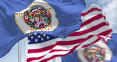 Minnesota state flags waving along with the national flag of the US Stock Footage 196879899
