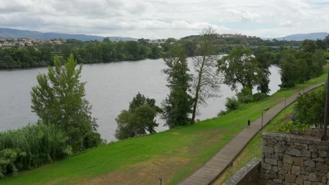 Mino river slowly passing by the medieval city of Tui, on the border between Stock Footage 286245719