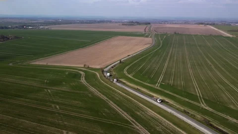 A minor road winding through fields of newly planted wheat.  Berkshire downs. UK Stock Footage 150820867