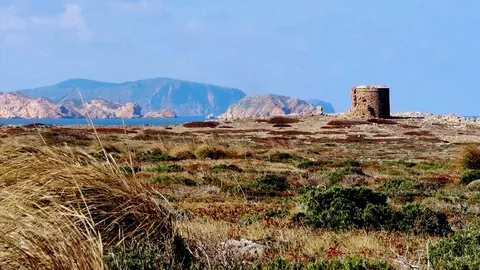 Minorca, Menorca, old defense tower with mighty mountains, Cap de Cavalleria Video stock 73107564
