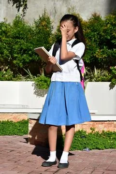 Minority Female Student Memory Problems Wearing Skirt With Textbooks Standing 스톡 사진