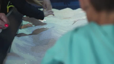 Minors Playing and Digging in Interactive Sandbox Stock Footage 203851905