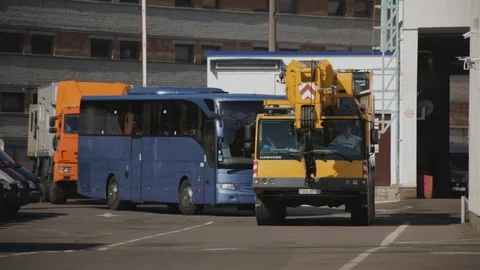 MINSK, BELARUS 08.05.16: Telescopic mobile crane Liebherr, passenger bus Stock-Footage 129359341