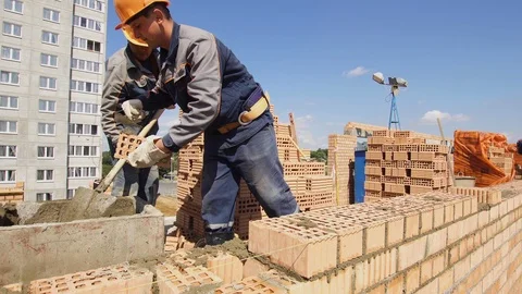 Minsk, Belarus, August 14 2018 - Builders working on apartment building of brick Stock Footage 101514059