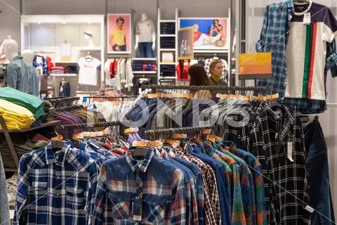Minsk, Belarus - May 29, 2019: interior shot of racks with shirts and Stock Photos