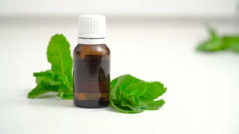Mint essential oils in a dark glass bottle on a white background 動画素材 149303665