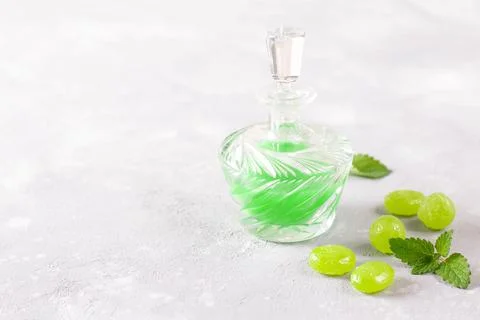 The mint extract in a jar and mint candies. Copy space. Stock Photos