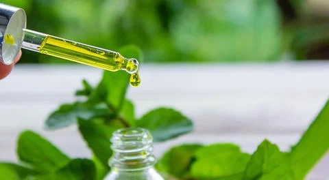 The mint extract in a small jar. Stock Photos
