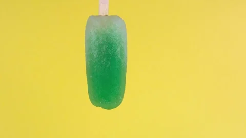 Mint flavored popsicle that melts quickly in time lapse Stock Footage 243711113