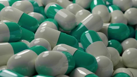 Mint green and white capsules on a conveyor Stock Footage 253597269