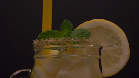 Mint Leaf Falling on Lemonade Jar with Straw 4K 스톡 동영상 131053576