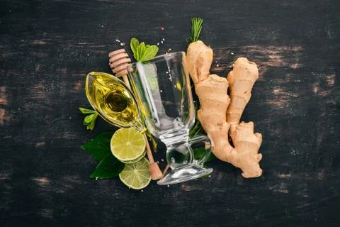 Mint, lime, ginger and lemon. On a wooden background. Top view. Copy space. Stock Photos