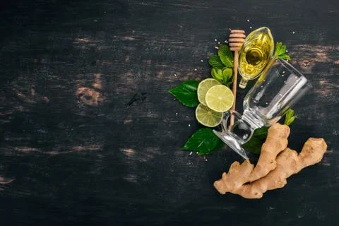 Mint, lime, ginger and lemon. On a wooden background. Top view. Copy space. Stock Photos