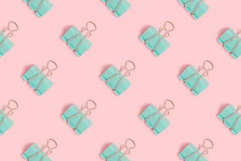 Mint paper clips pattern on a pink pastel background. Stock Photos