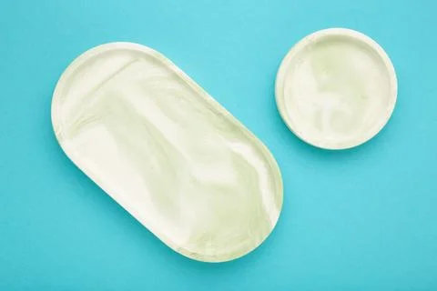 Mint plaster trays on blue background. Stands for candles or jewelry Stock Photos