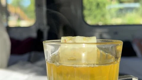 Mint tea drink from glass cup on train with iron mug stand Stock Footage 316074954