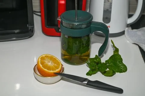 Mint tea with lemon in the kitchen 2 Stock Photos