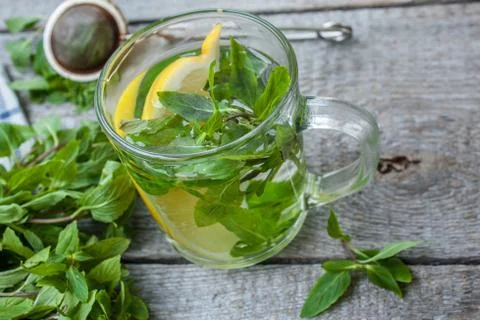 Mint tea with lemon, mint and tea strainer. Stock Photos