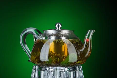 Mint tea in a transparent teapot Stock Photos